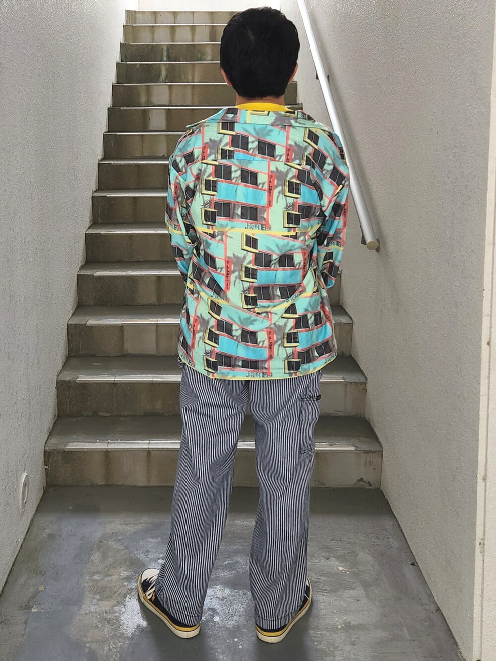 ブルー系のその他パンツ、ブルー系のスニーカー、イエロー系のTシャツ/カットソーを着用したメンズの秋コーディネートの2枚目の写真