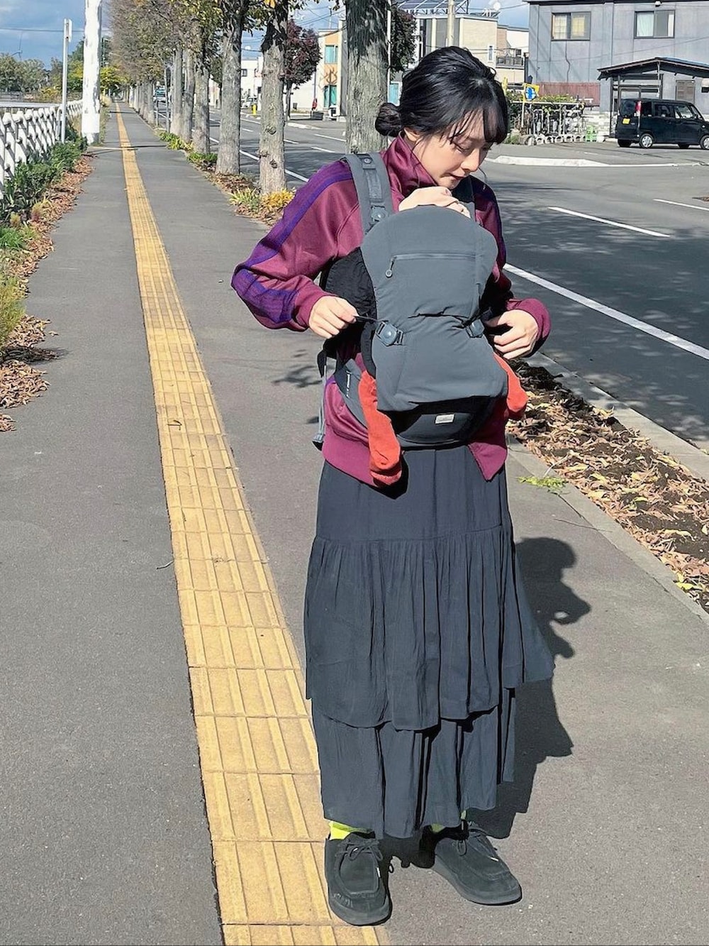 パープル系のジャケット/アウター、ブラック系のスカート、ブラック系のその他シューズを着用したキッズの冬コーディネートの2枚目の写真