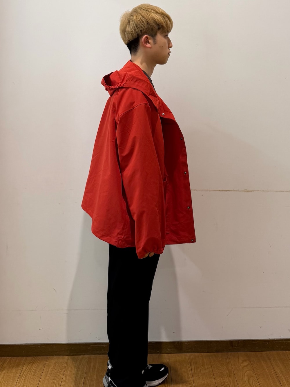 ブラック系のその他パンツ、ブラウン系のTシャツ/カットソー、レッド系のブルゾンを着用したメンズの秋コーディネートの2枚目の写真