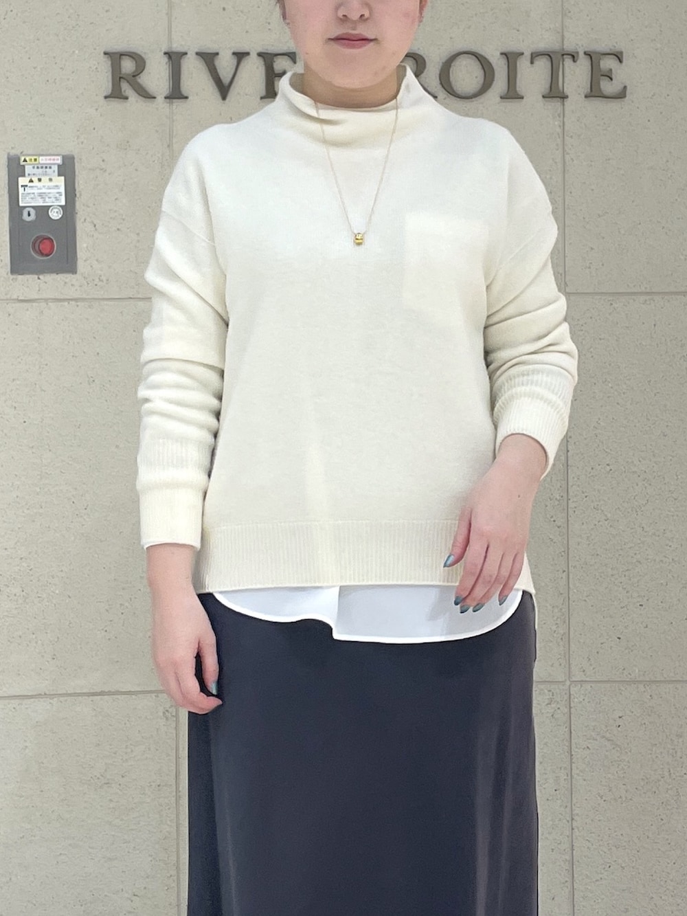 ホワイト系のニット/セーター、ホワイト系のシャツ/ブラウス、ブラック系のブーツを着用したレディースの冬コーディネートの5枚目の写真