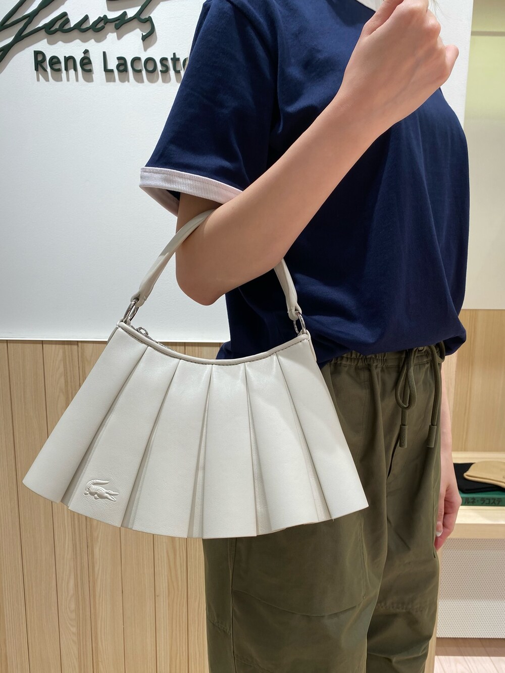 ブルー系のTシャツ/カットソー、グリーン系のカーゴパンツ、ホワイト系のスニーカーを着用したレディースの秋コーディネートの6枚目の写真