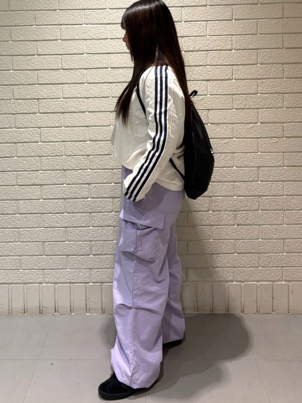 ホワイト系のTシャツ/カットソー、ブラック系のエコバッグ/サブバッグ、ブラック系のスニーカーを着用したレディースの秋コーディネートの2枚目の写真