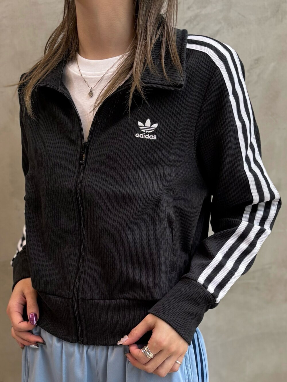 ブラック系のシューズアクセサリー、ブラック系のショルダーバッグ、ブルー系のスウェットパンツを着用したレディースの冬コーディネートの2枚目の写真