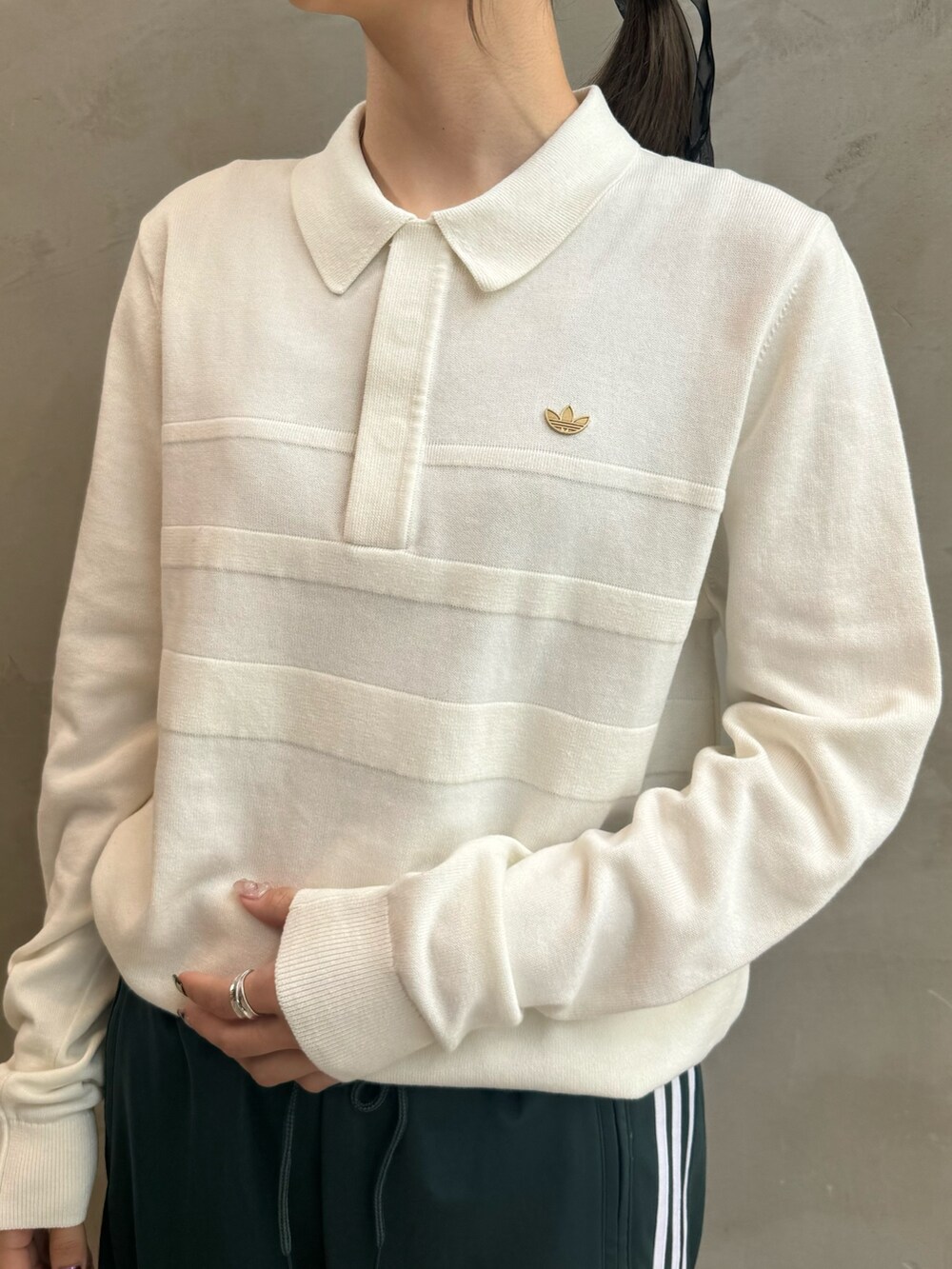 ブラック系のダウンジャケット/コート、ホワイト系のポロシャツ、グリーン系のスウェットパンツを着用したレディースの秋コーディネートの6枚目の写真