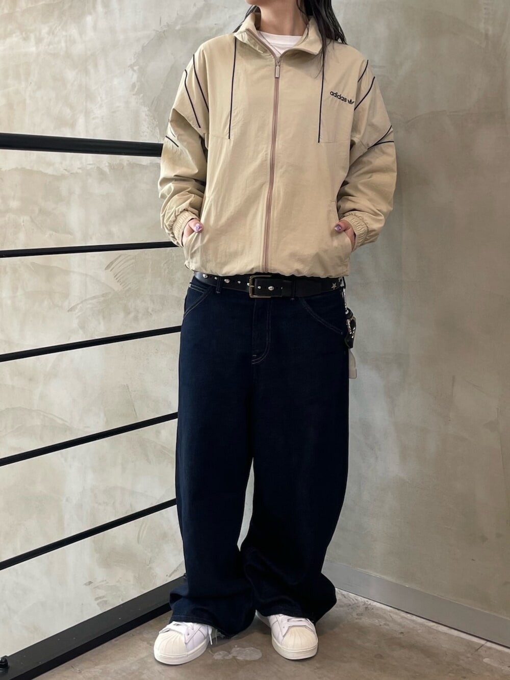 ベージュ系のジャージ、ホワイト系のスニーカーを着用したレディースの春コーディネートの2枚目の写真