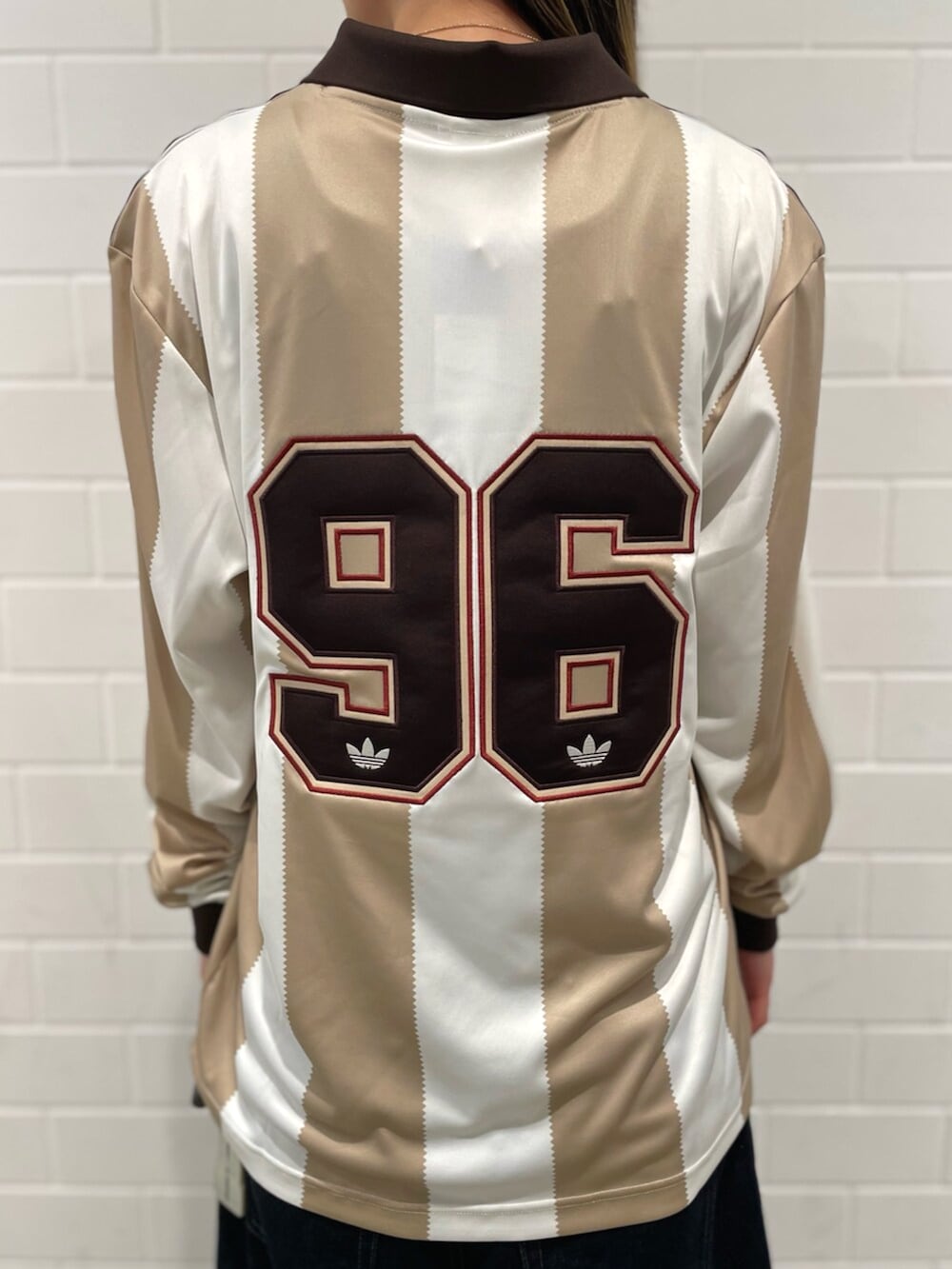 ホワイト系のTシャツ/カットソー、ブラウン系のスニーカー、ブルー系のショルダーバッグを着用したレディースの春コーディネートの4枚目の写真