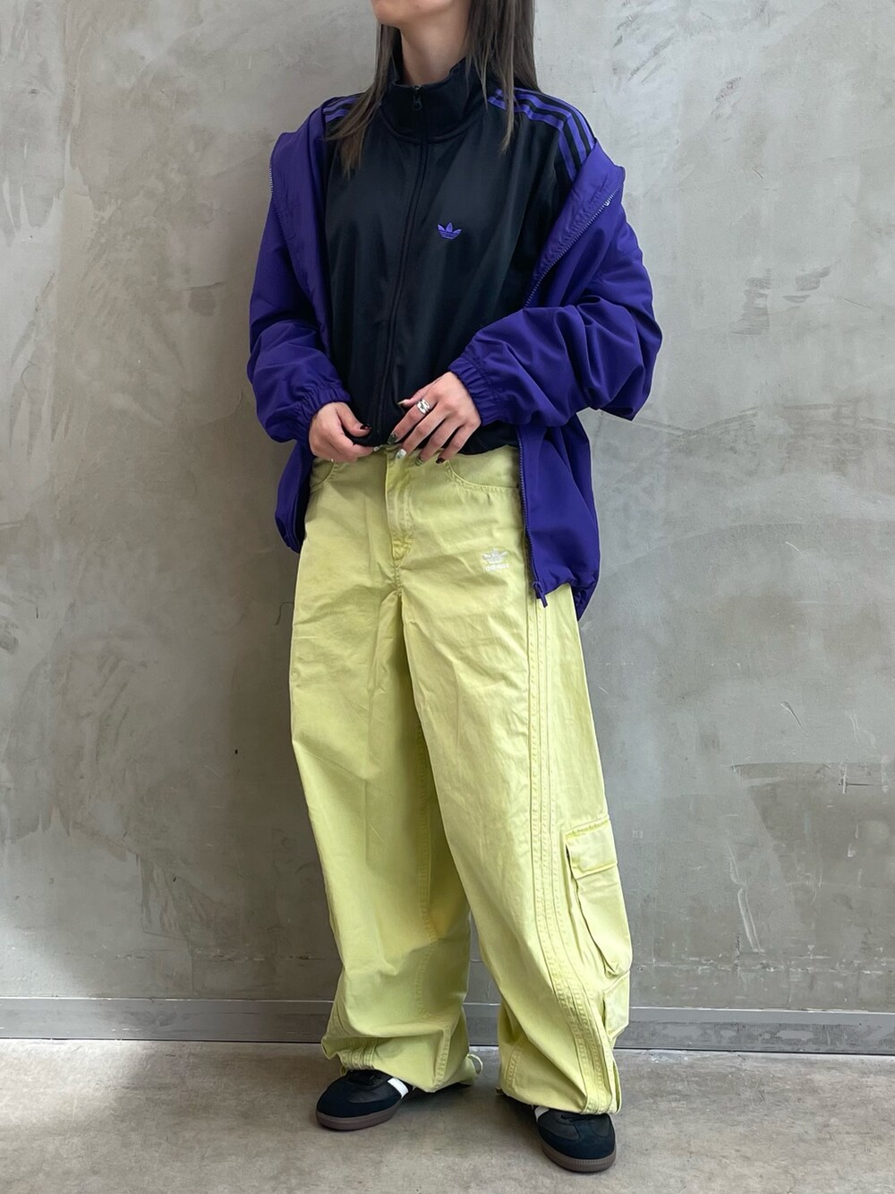 ブラック系のジャージ、グリーン系のカーゴパンツ、ブラック系のシューズを着用したレディースの秋コーディネートの2枚目の写真