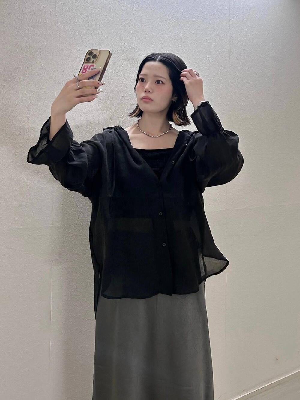 グレー系のスカート、ブラック系のシャツ/ブラウスを着用したレディースの夏コーディネートの2枚目の写真