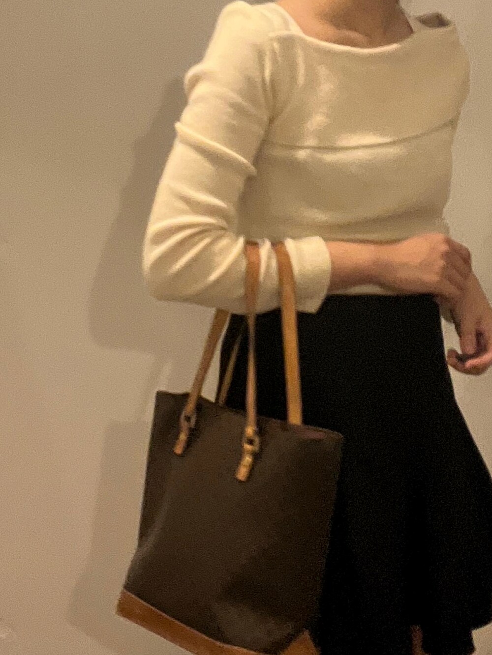 ホワイト系のニット/セーター、ブラック系のスカートを着用したレディースの秋コーディネートの4枚目の写真