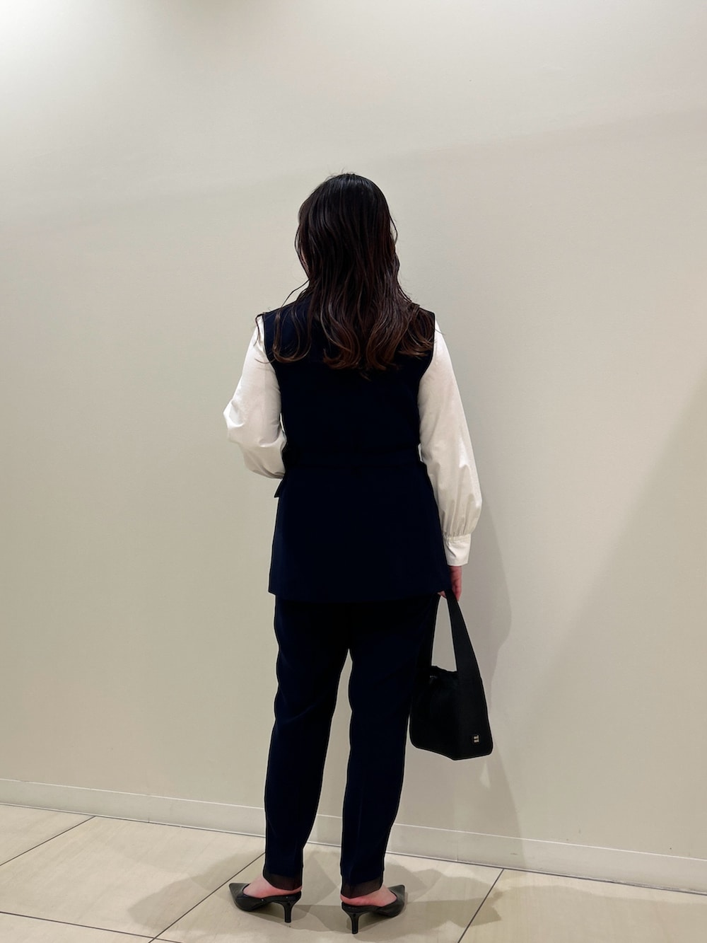 ブルー系のベスト、ブルー系のその他パンツ、ホワイト系のシャツ/ブラウスを着用したレディースの春コーディネートの3枚目の写真