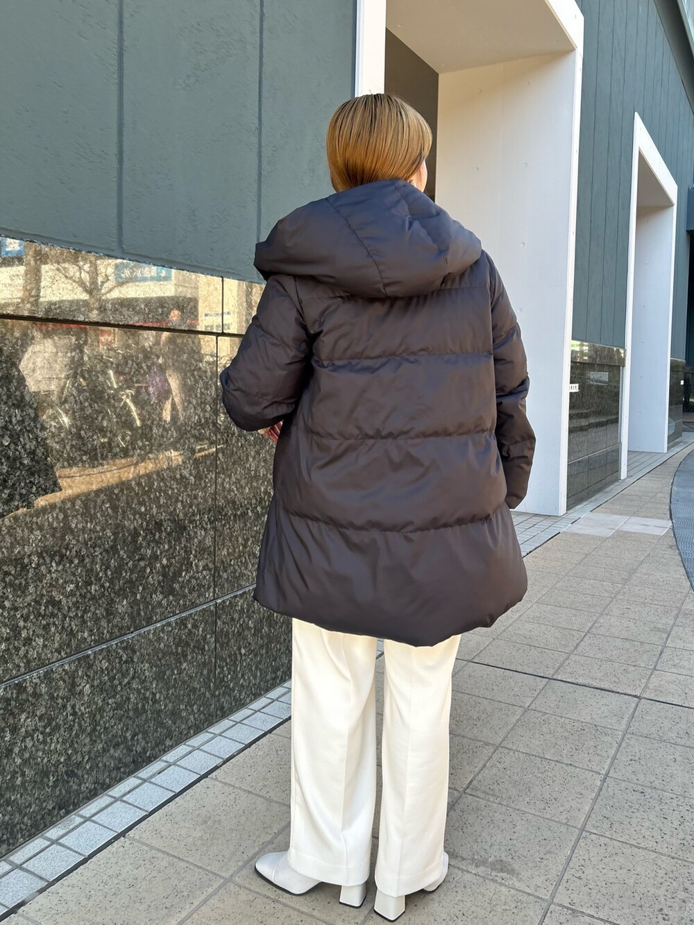 ブラック系のダウンジャケット/コート、グレー系のカーディガン/ボレロ、ホワイト系のTシャツ/カットソーを着用したレディースの冬コーディネートの4枚目の写真