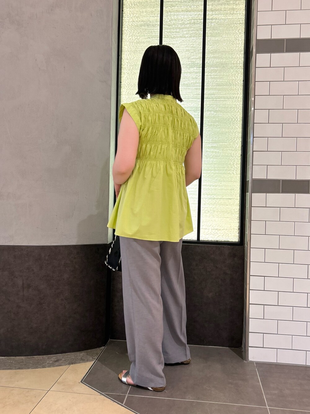 グリーン系のシャツ/ブラウス、ブラック系のトートバッグ、グレー系のその他パンツを着用したレディースの夏コーディネートの4枚目の写真