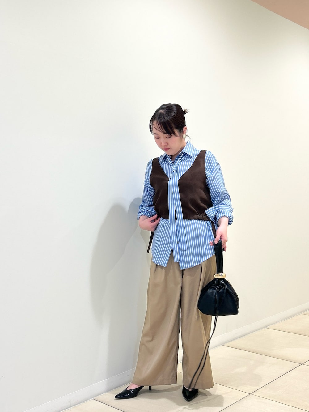 ブルー系のシャツ/ブラウス、ベージュ系のその他パンツ、ブラウン系のベストを着用したレディースの夏コーディネートの5枚目の写真