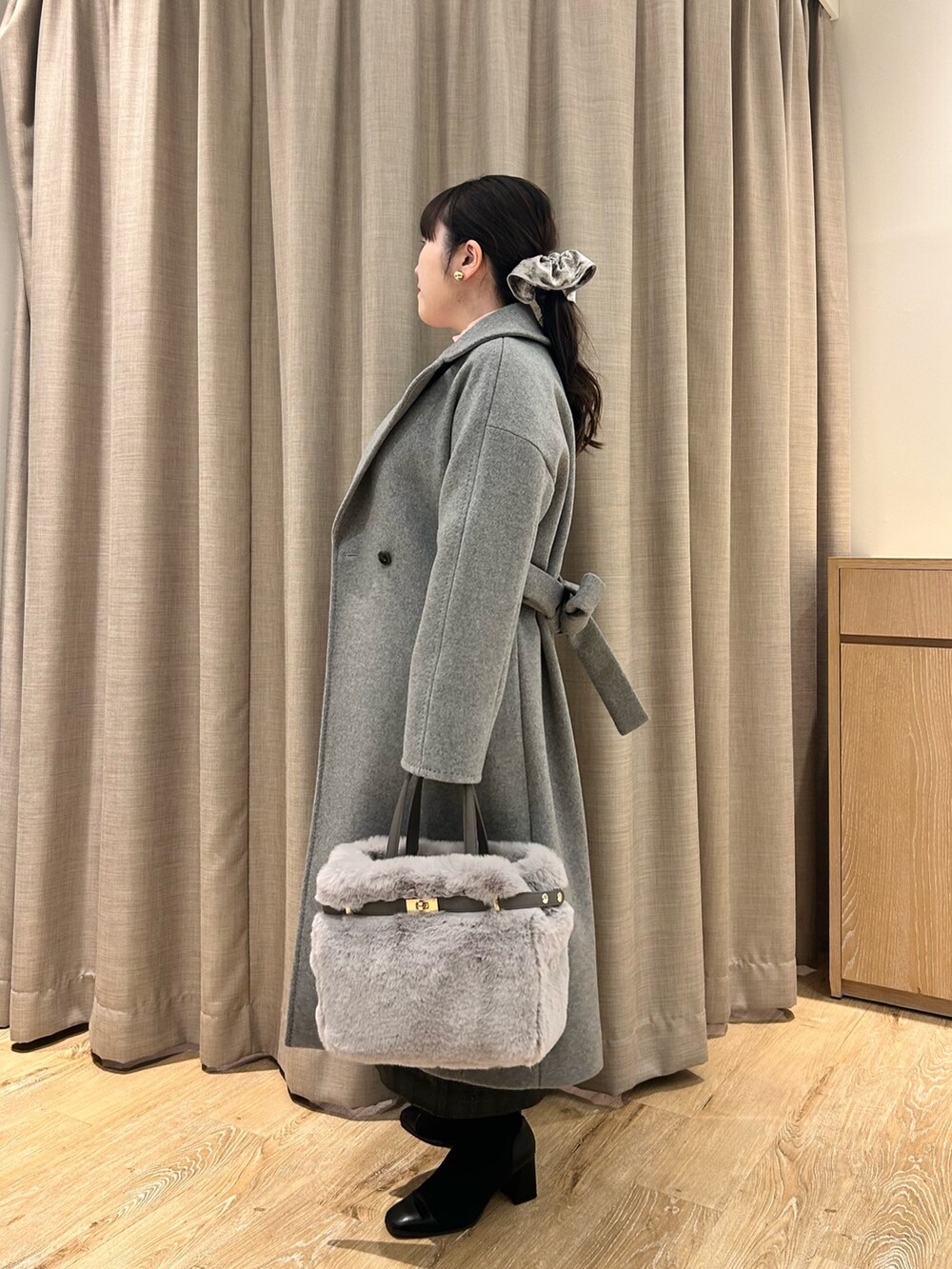 グレー系のその他アウター、ピンク系のニット/セーター、ブラック系のスカートを着用したレディースの冬コーディネートの2枚目の写真