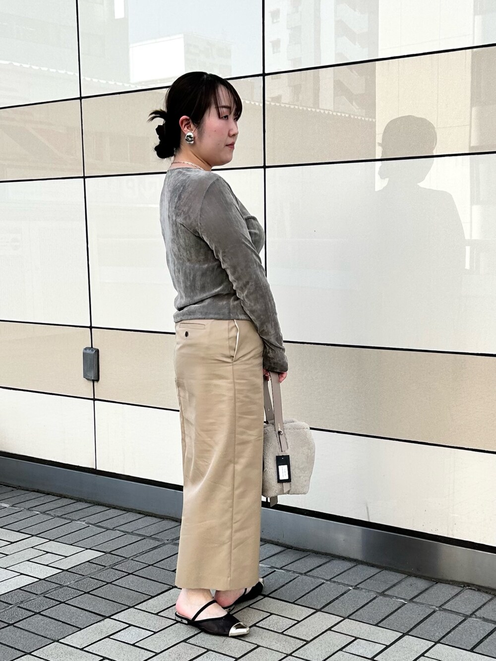 グレー系のカーディガン/ボレロ、ベージュ系のスカート、ベージュ系のショルダーバッグを着用したレディースの秋コーディネートの4枚目の写真