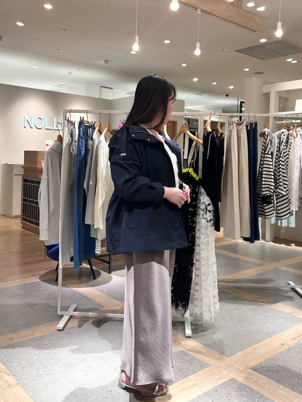 ホワイト系のカーディガン/ボレロ、グリーン系のスカート、ブルー系のブルゾンを着用したレディースの春コーディネートの4枚目の写真