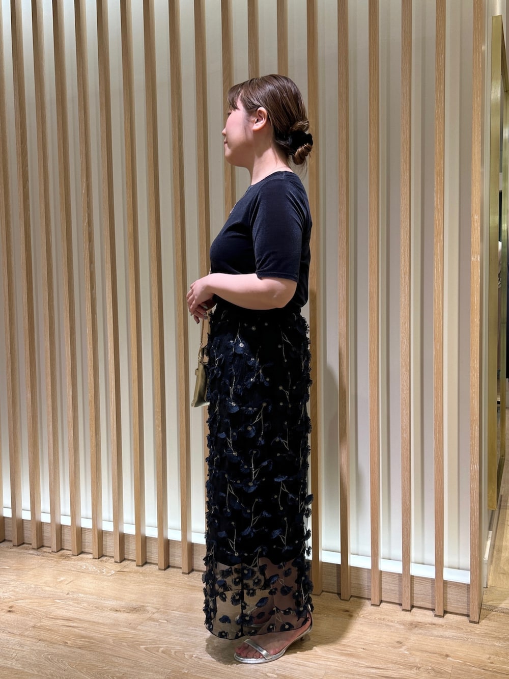 ブルー系のTシャツ/カットソー、ブルー系のスカート、ゴールド系のショルダーバッグを着用したレディースの秋コーディネートの2枚目の写真