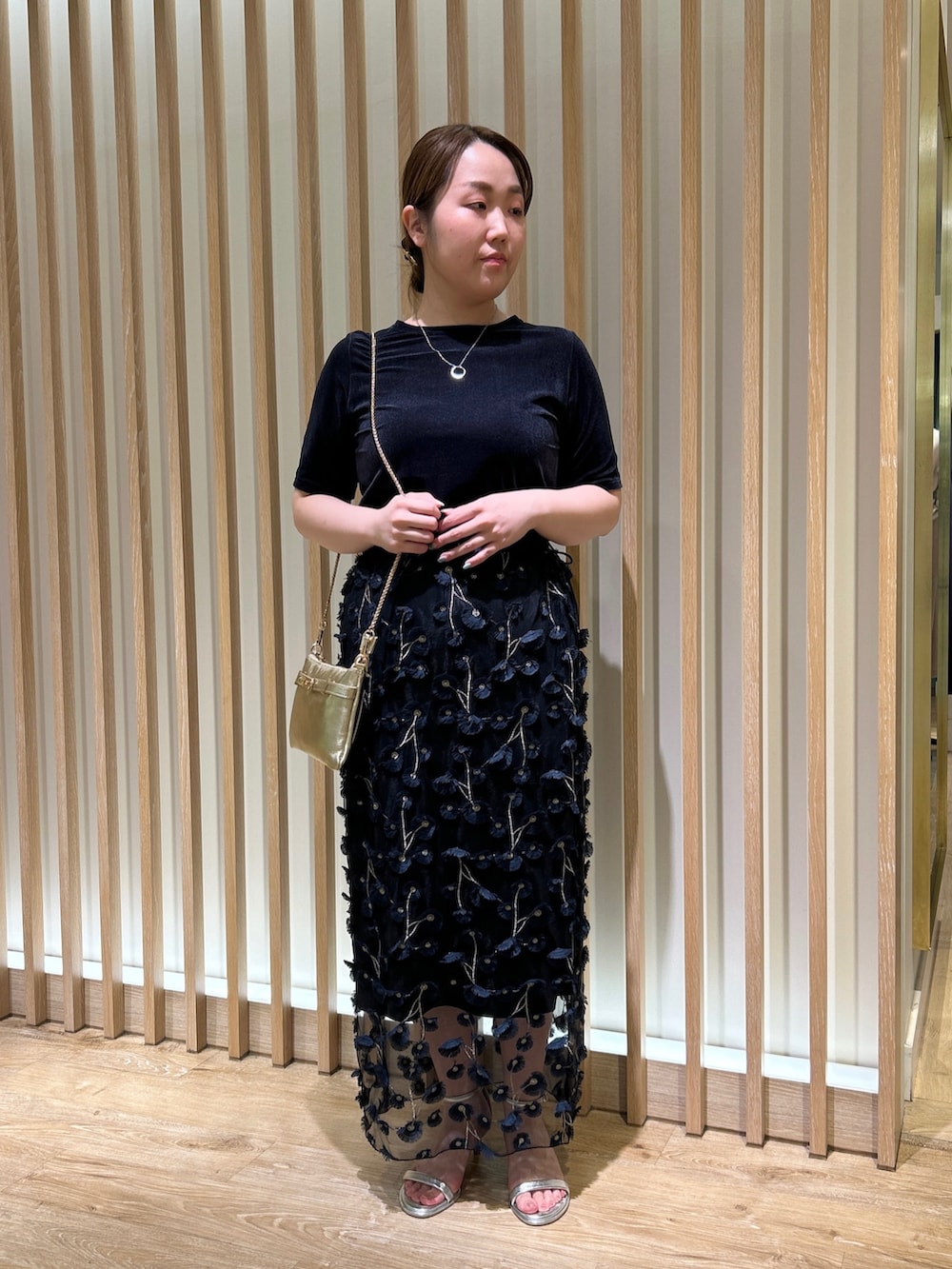 ブルー系のTシャツ/カットソー、ブルー系のスカート、ゴールド系のショルダーバッグを着用したレディースの秋コーディネートの8枚目の写真