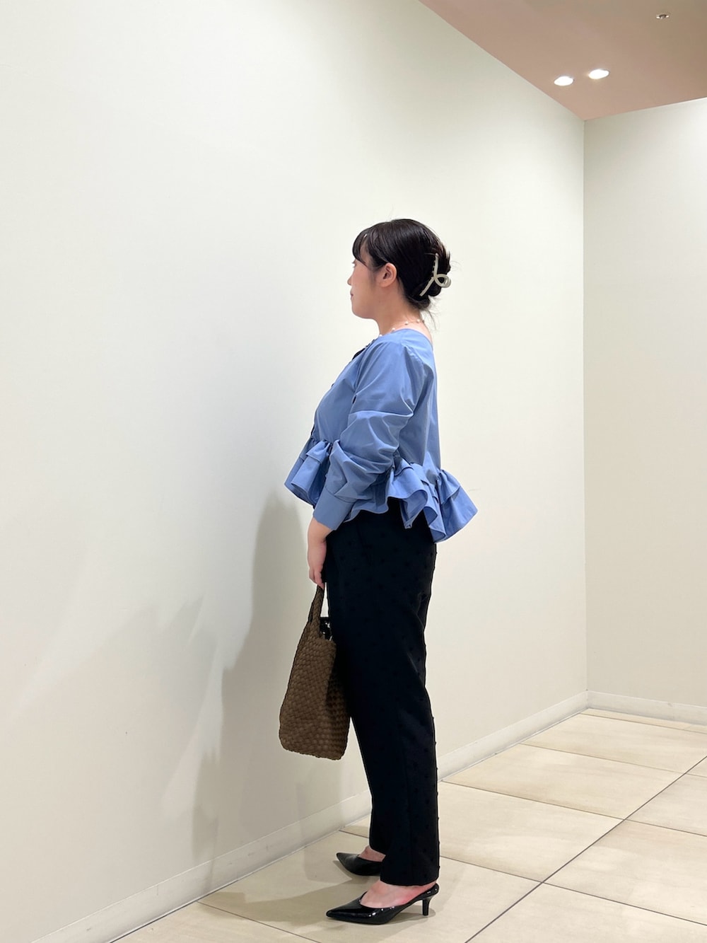 ブルー系のシャツ/ブラウス、ブラック系のその他パンツ、ブラウン系のトートバッグを着用したレディースの秋コーディネートの2枚目の写真