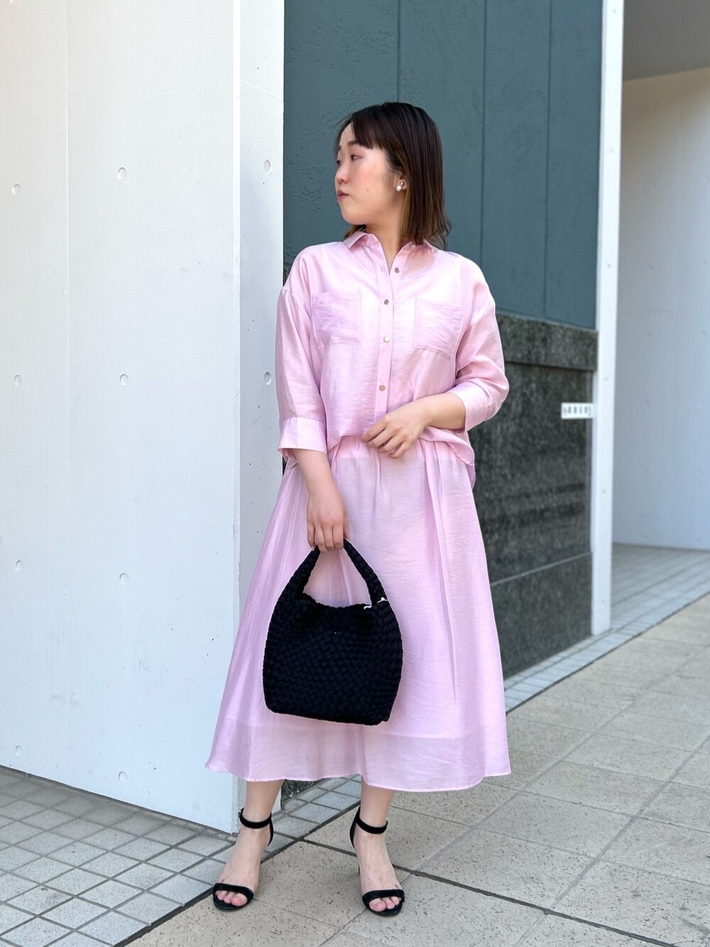 ピンク系のシャツ/ブラウス、ピンク系のスカート、ブラック系のショルダーバッグを着用したレディースの春コーディネートの8枚目の写真
