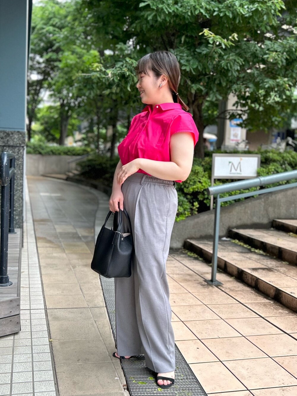 ピンク系のシャツ/ブラウス、ブラック系のトートバッグ、グレー系のその他パンツを着用したレディースの夏コーディネートの4枚目の写真