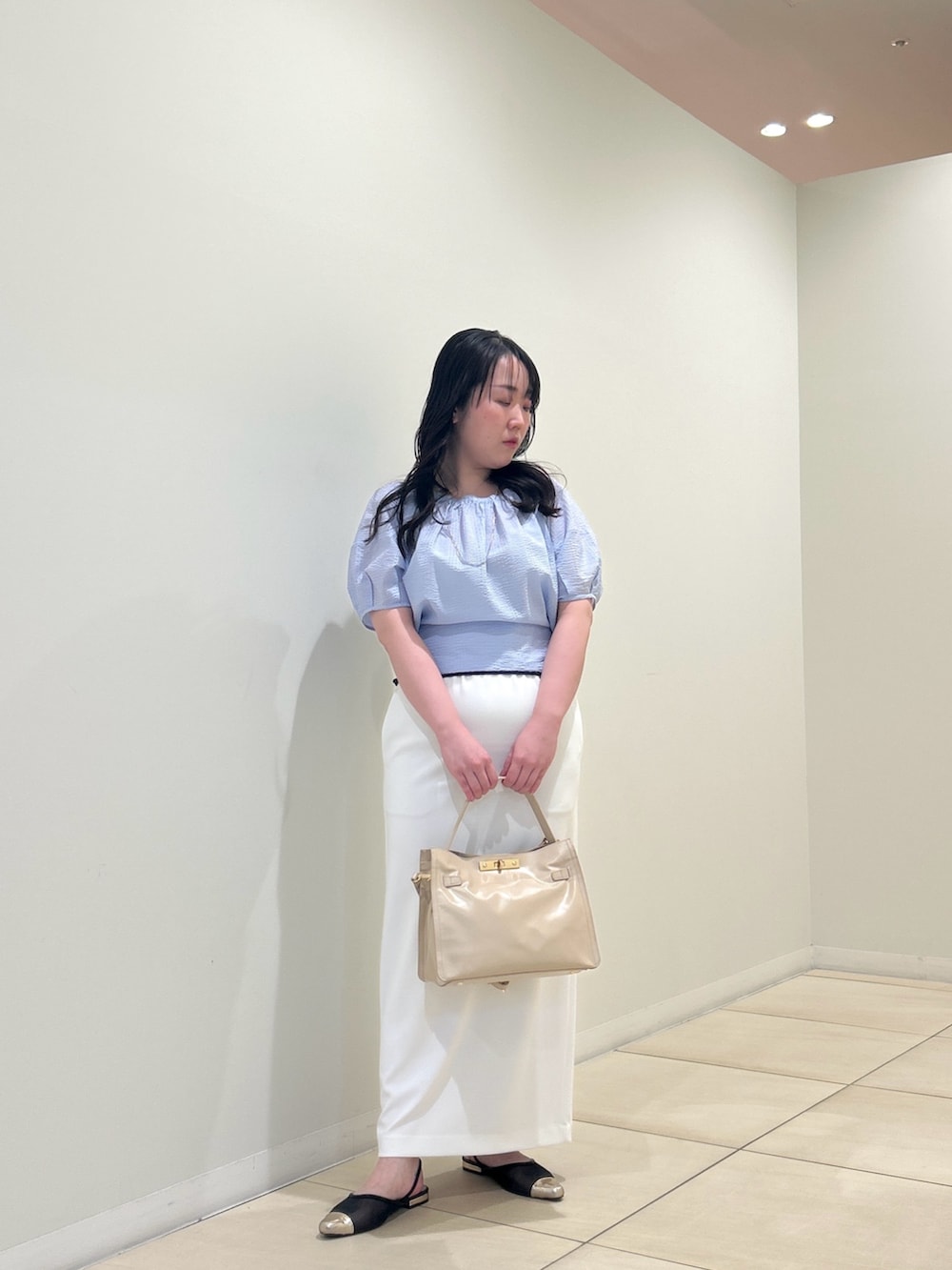 ブルー系のシャツ/ブラウス、ホワイト系のスカート、ベージュ系のトートバッグを着用したレディースの夏コーディネートの5枚目の写真