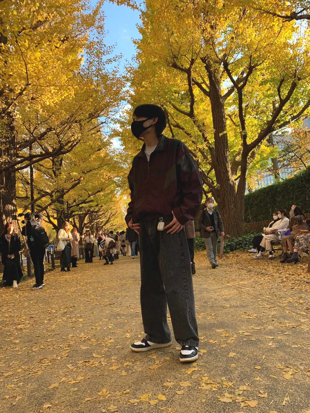 ブラック系のデニムパンツ、その他のスニーカー、レッド系のナイロンジャケットを着用したメンズの秋コーディネートの2枚目の写真