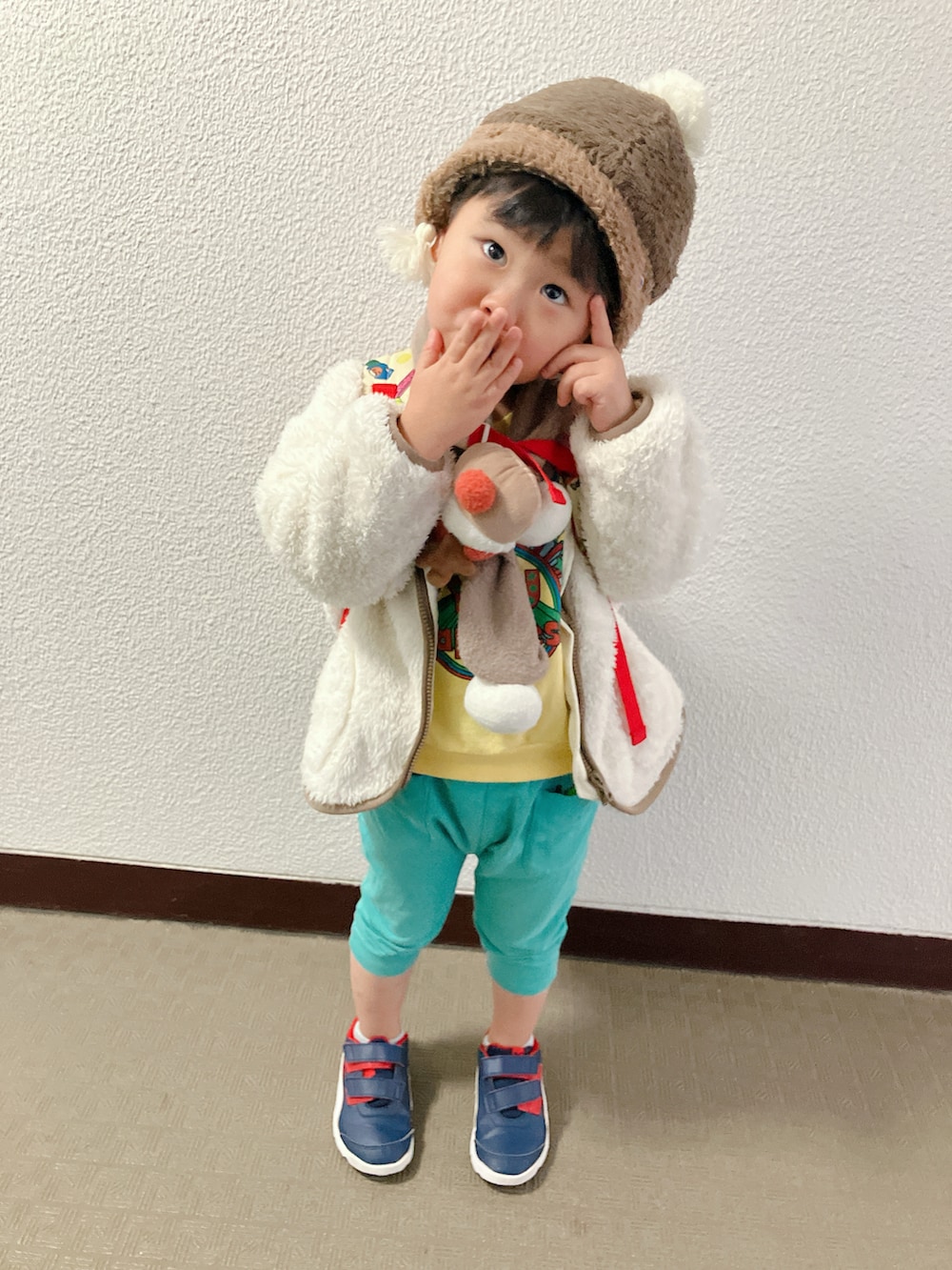 ホワイト系のムートンコートを着用したキッズの冬コーディネートの3枚目の写真