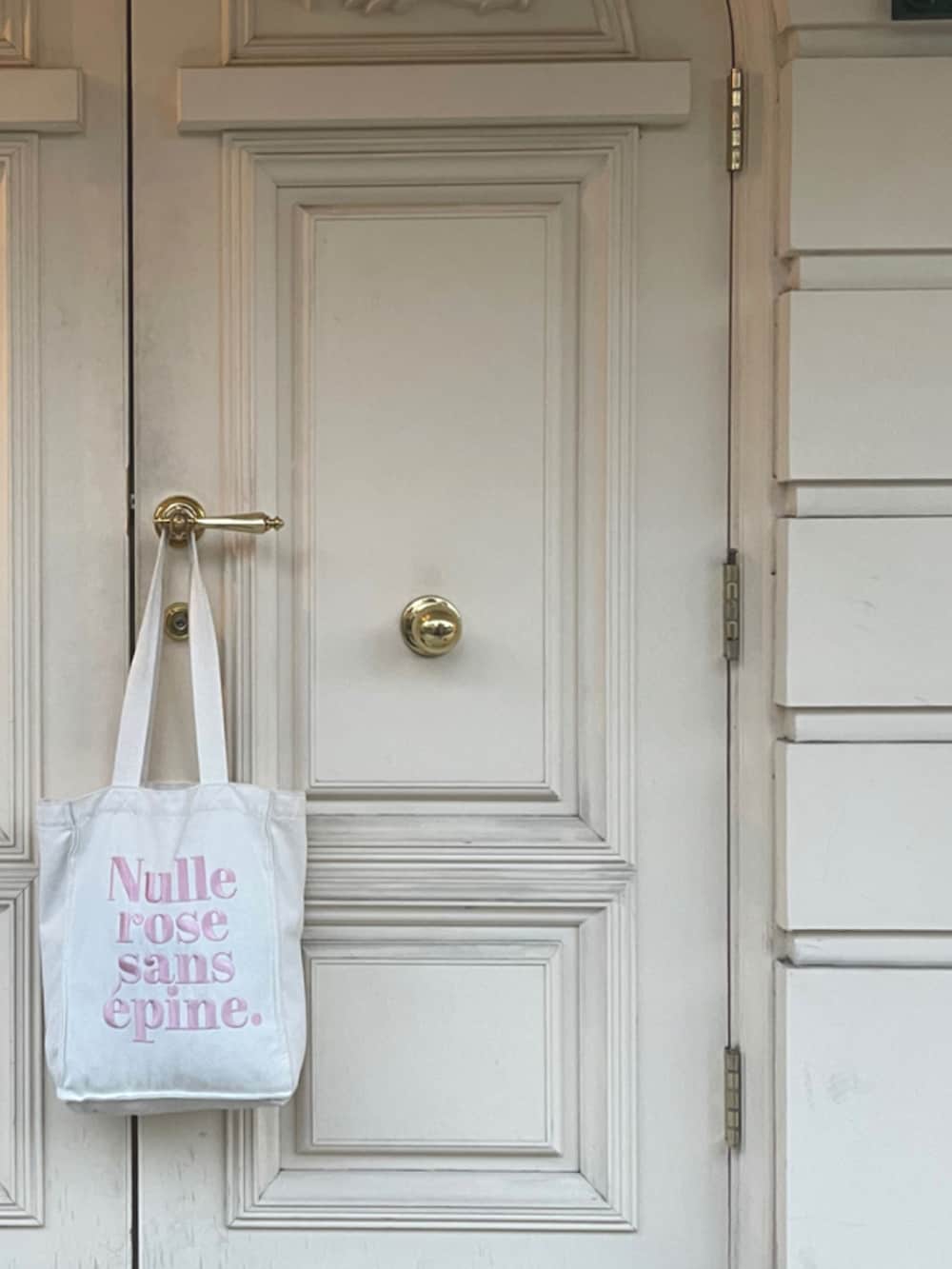 ホワイト系のテーラードジャケット、ブラック系のTシャツ/カットソー、ブルー系のデニムパンツを着用したレディースの秋コーディネートの2枚目の写真