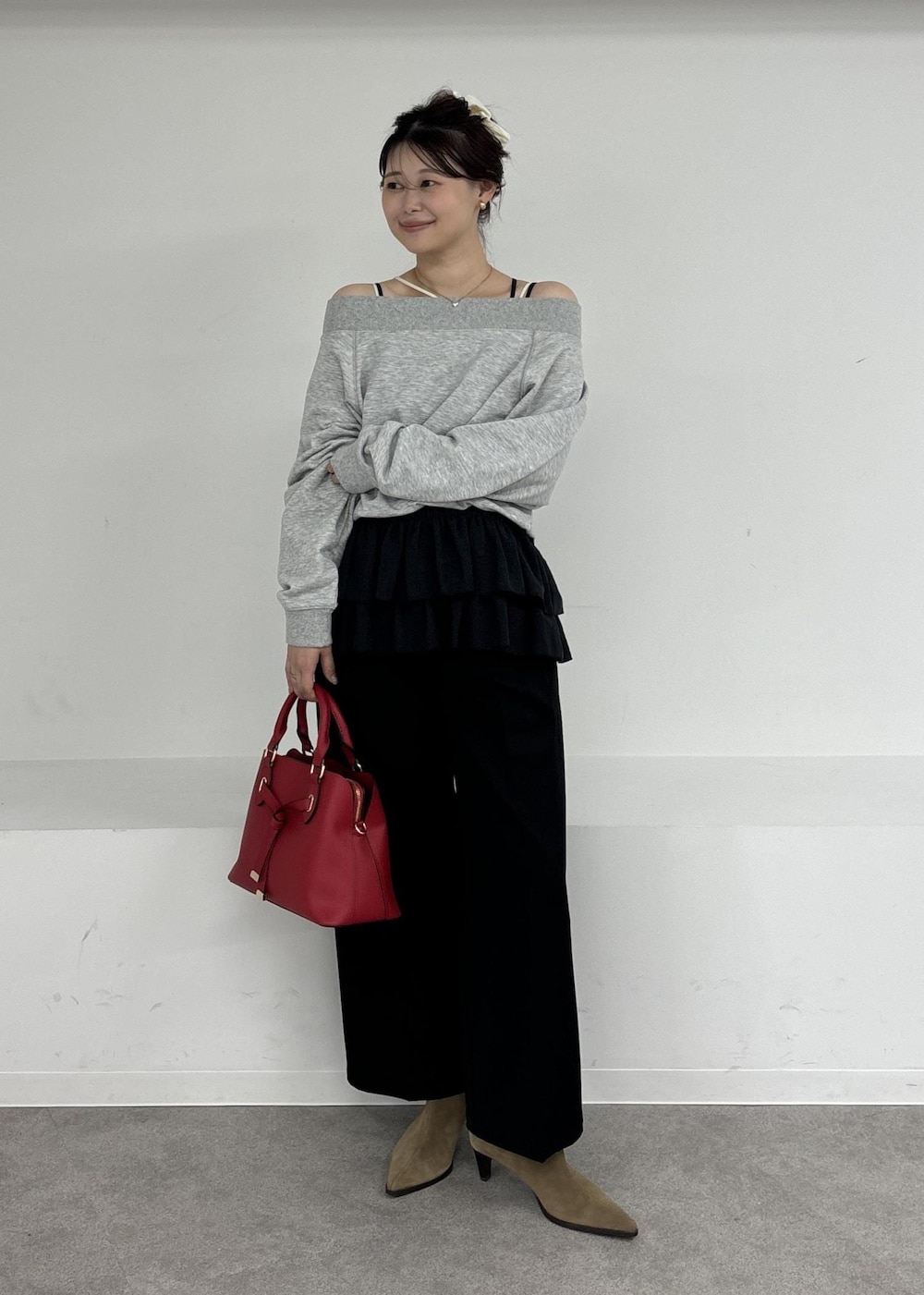 レッド系のボストンバッグ、ブラック系のキャミソール、グレー系のスウェットを着用したレディースの秋コーディネートの2枚目の写真