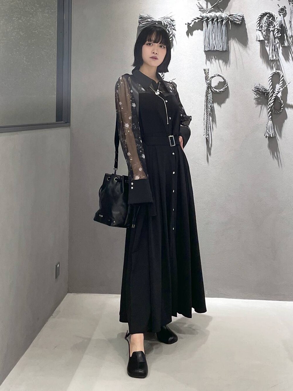 グレー系のタンクトップ、ブラック系のパンプス、ブラック系のショルダーバッグを着用したレディースの夏コーディネートの5枚目の写真