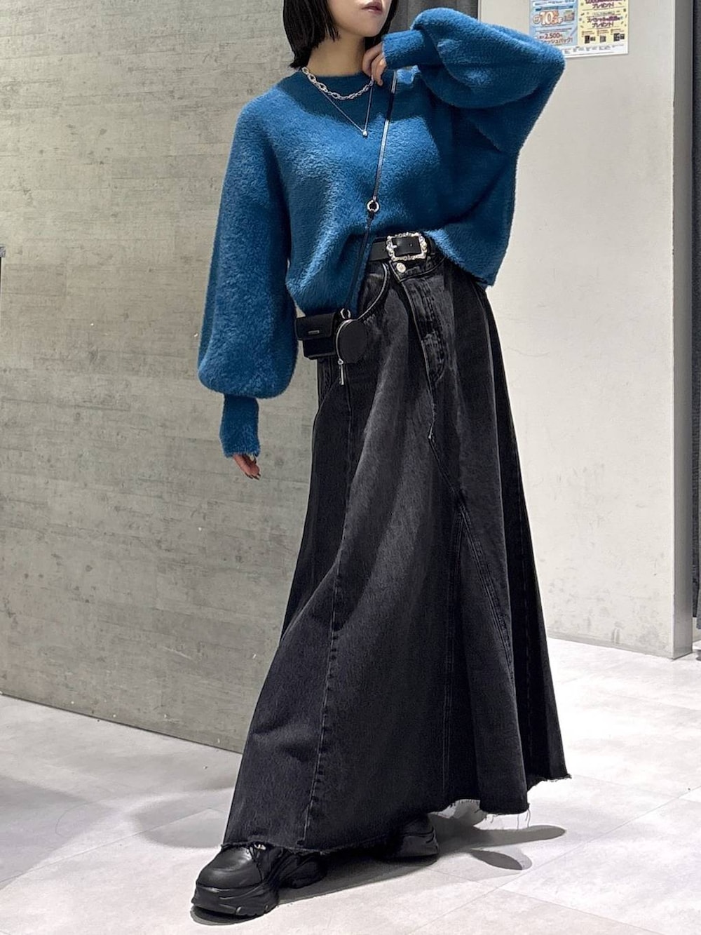 グレー系のタンクトップ、ブルー系のニット/セーター、ブラック系のブーツを着用したレディースの秋コーディネートの4枚目の写真