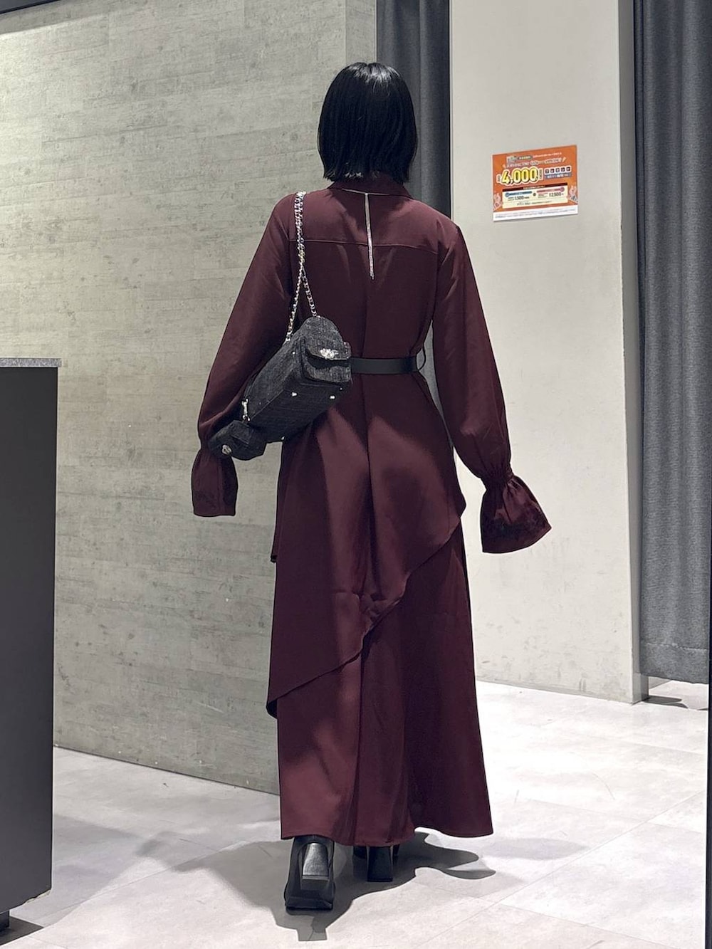 ブラック系のネクタイ、グレー系のタンクトップ、ブラック系のブーツを着用したレディースの秋コーディネートの7枚目の写真