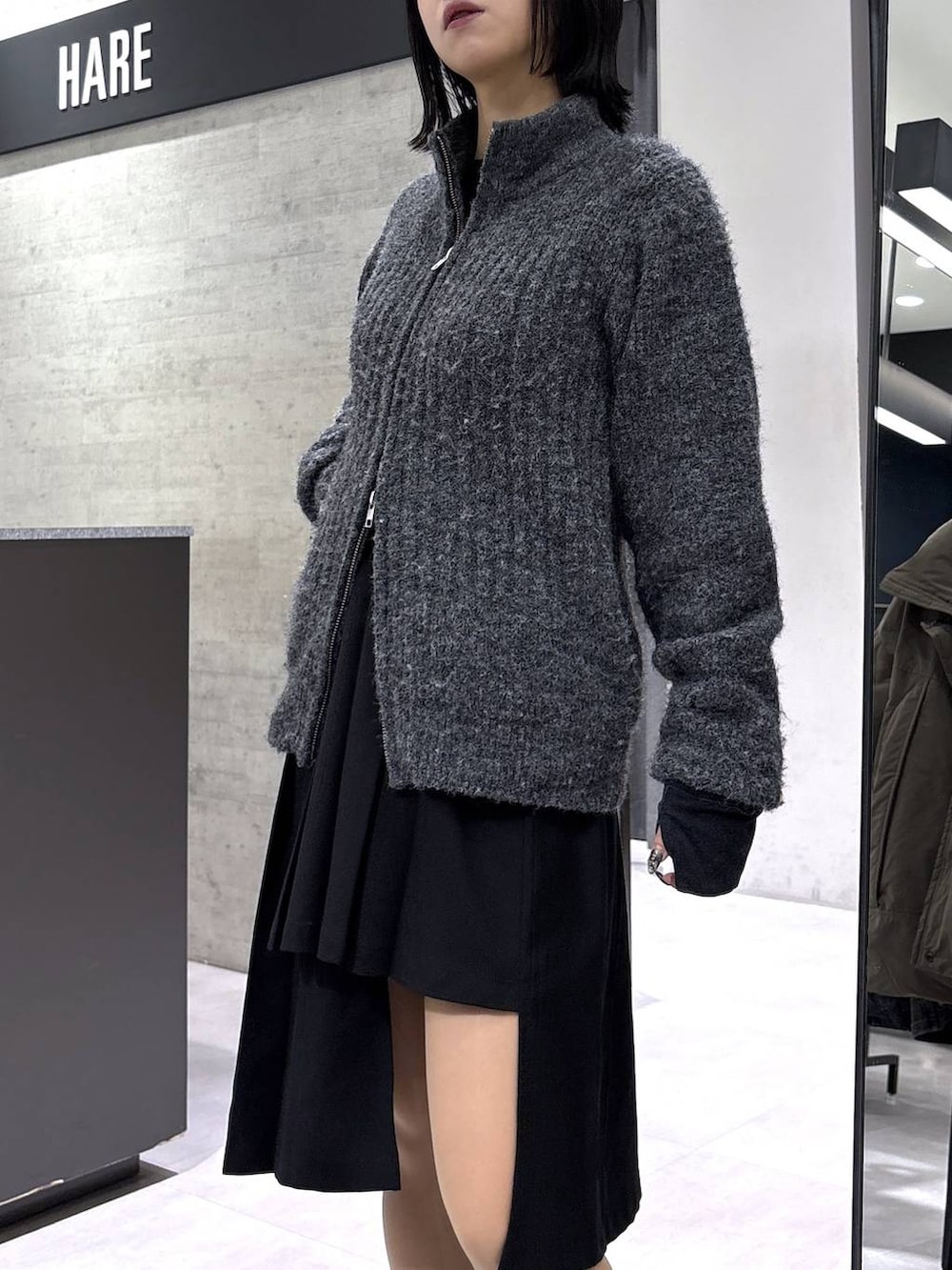 ブラック系のスカート、グレー系のカーディガン/ボレロ、ブラック系のベルトを着用したレディースの冬コーディネートの8枚目の写真