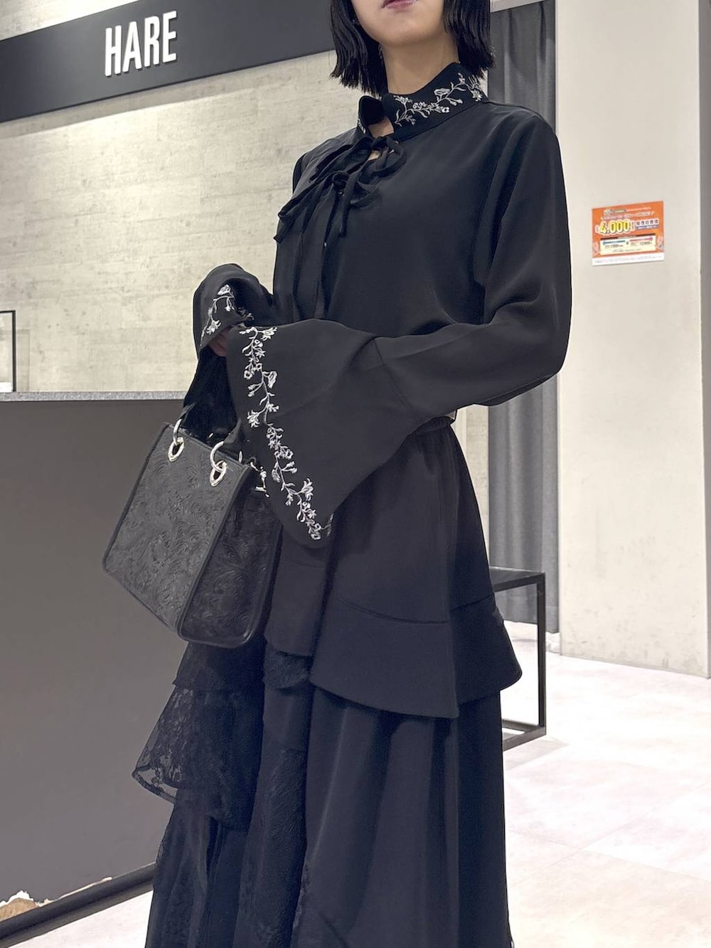 ブラック系のショルダーバッグ、ブラック系のシャツ/ブラウス、ブラック系のブーツを着用したレディースの秋コーディネートの8枚目の写真