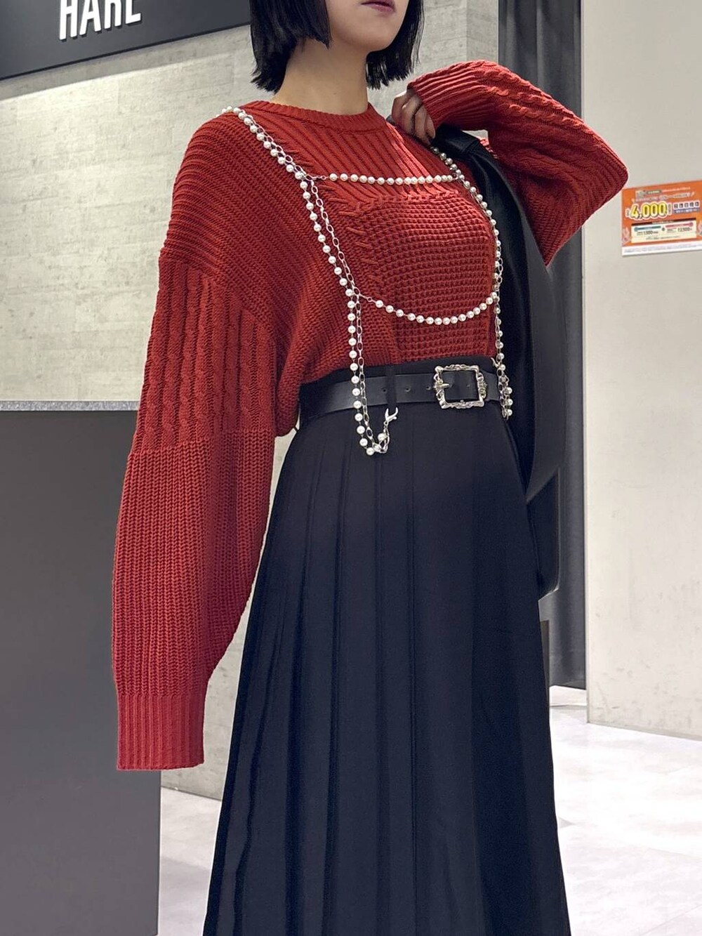 ブラック系のタンクトップ、ブラック系のトートバッグ、ブラック系のブーツを着用したレディースの秋コーディネートの8枚目の写真