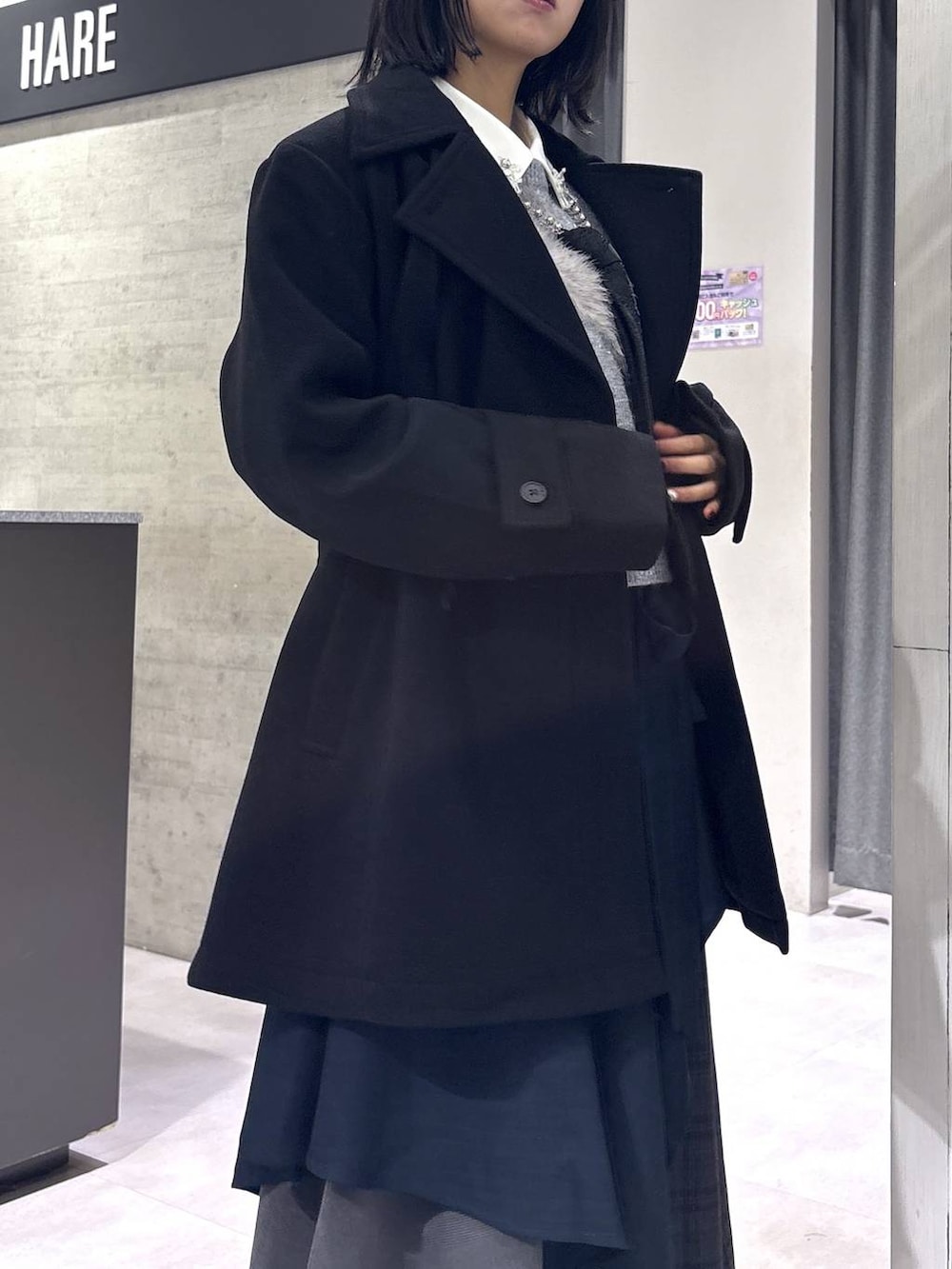 ブラック系のネクタイ、ブラック系のトレンチコート、グリーン系のブーツを着用したレディースの秋コーディネートの8枚目の写真