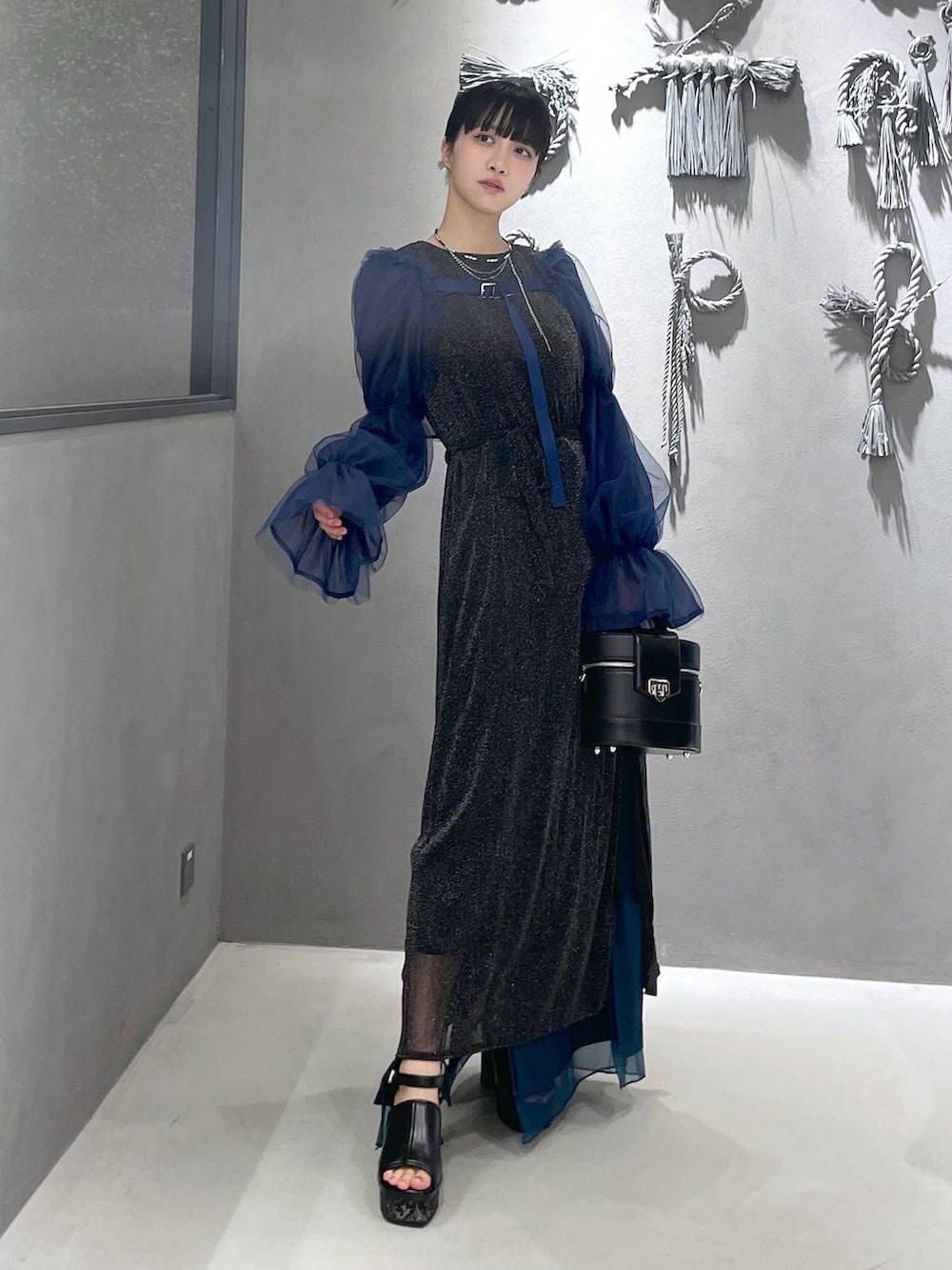 ブラック系のタンクトップ、グレー系のサンダル、ブラック系のショルダーバッグを着用したレディースの夏コーディネートの5枚目の写真