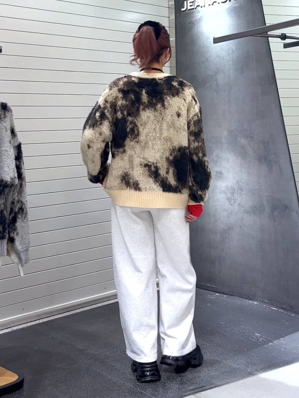 ブラウン系のニット/セーター、ブラック系のローファー、ベージュ系のスウェットパンツを着用したレディースの秋コーディネートの5枚目の写真