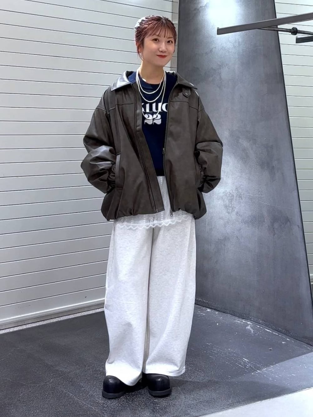 ブラウン系のブルゾン、ホワイト系のその他トップス、ブラック系のその他シューズを着用したレディースの冬コーディネートの3枚目の写真