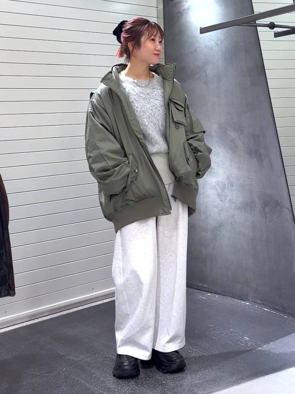 ホワイト系のTシャツ/カットソー、ブラック系のローファー、グリーン系のブルゾンを着用したレディースの冬コーディネートの3枚目の写真