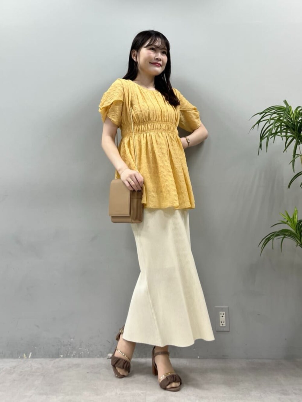 ブラウン系のその他シューズ、ベージュ系のショルダーバッグ、ホワイト系のスカートを着用したレディースの夏コーディネートの3枚目の写真