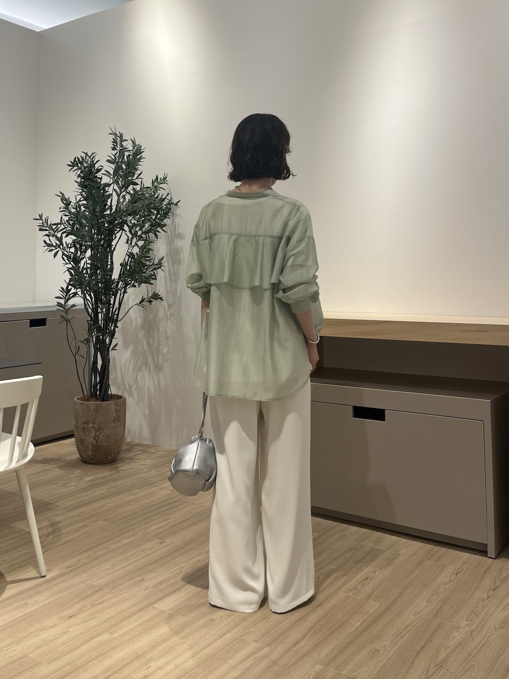 グリーン系のシャツ/ブラウス、ホワイト系のTシャツ/カットソー、シルバー系のトートバッグを着用したレディースの夏コーディネートの3枚目の写真