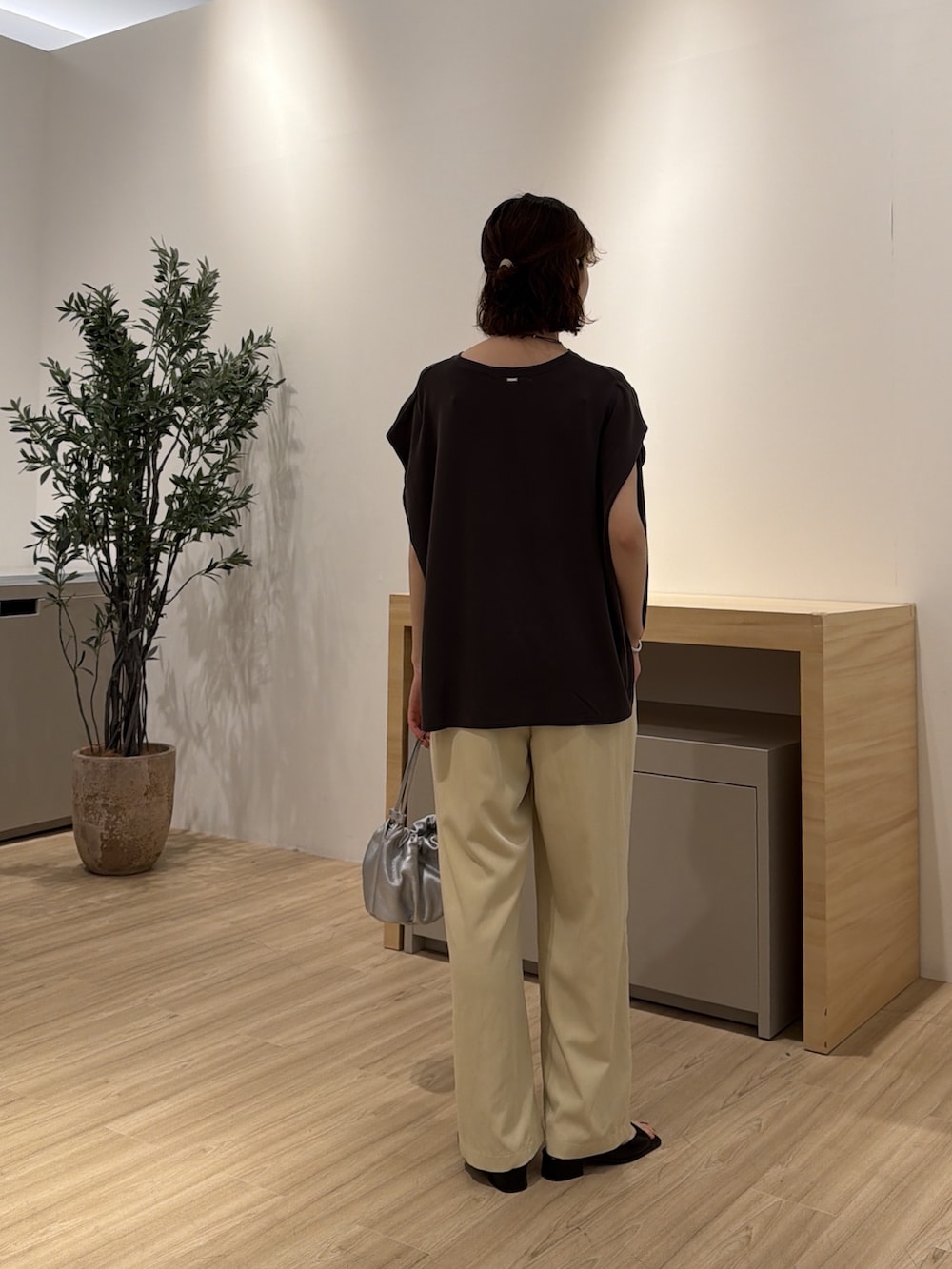 イエロー系のその他パンツ、グレー系のTシャツ/カットソー、シルバー系のトートバッグを着用したレディースの夏コーディネートの3枚目の写真
