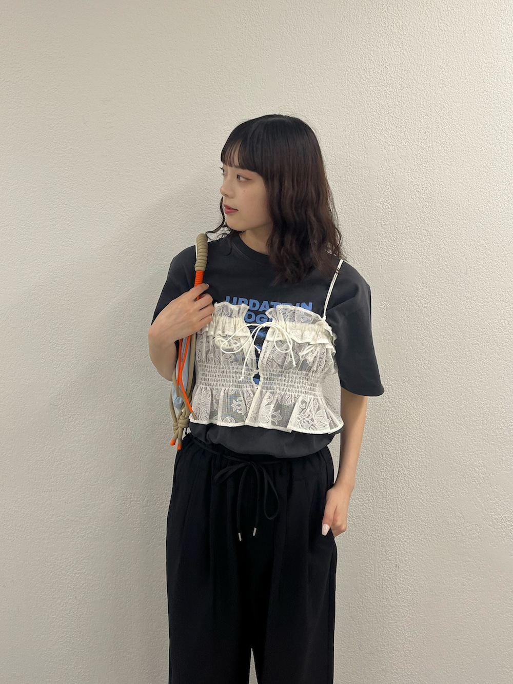 ブルー系のショルダーバッグ、ホワイト系のキャミソール、グレー系のTシャツ/カットソーを着用したレディースの春コーディネートの3枚目の写真