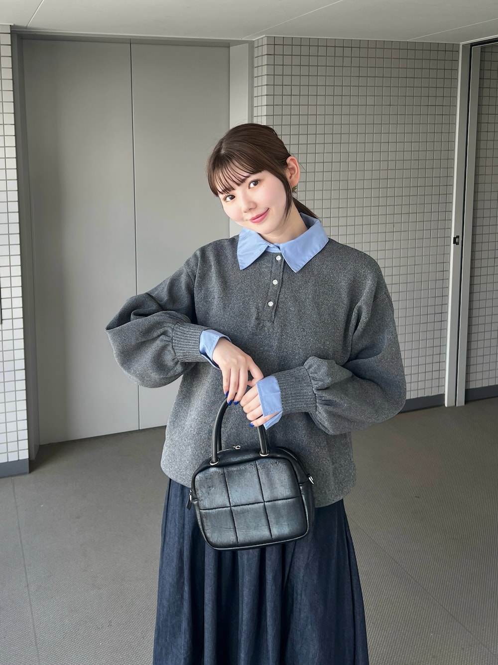 グレー系のニット/セーター、ブラック系のパンプスを着用したレディースの秋コーディネートの3枚目の写真