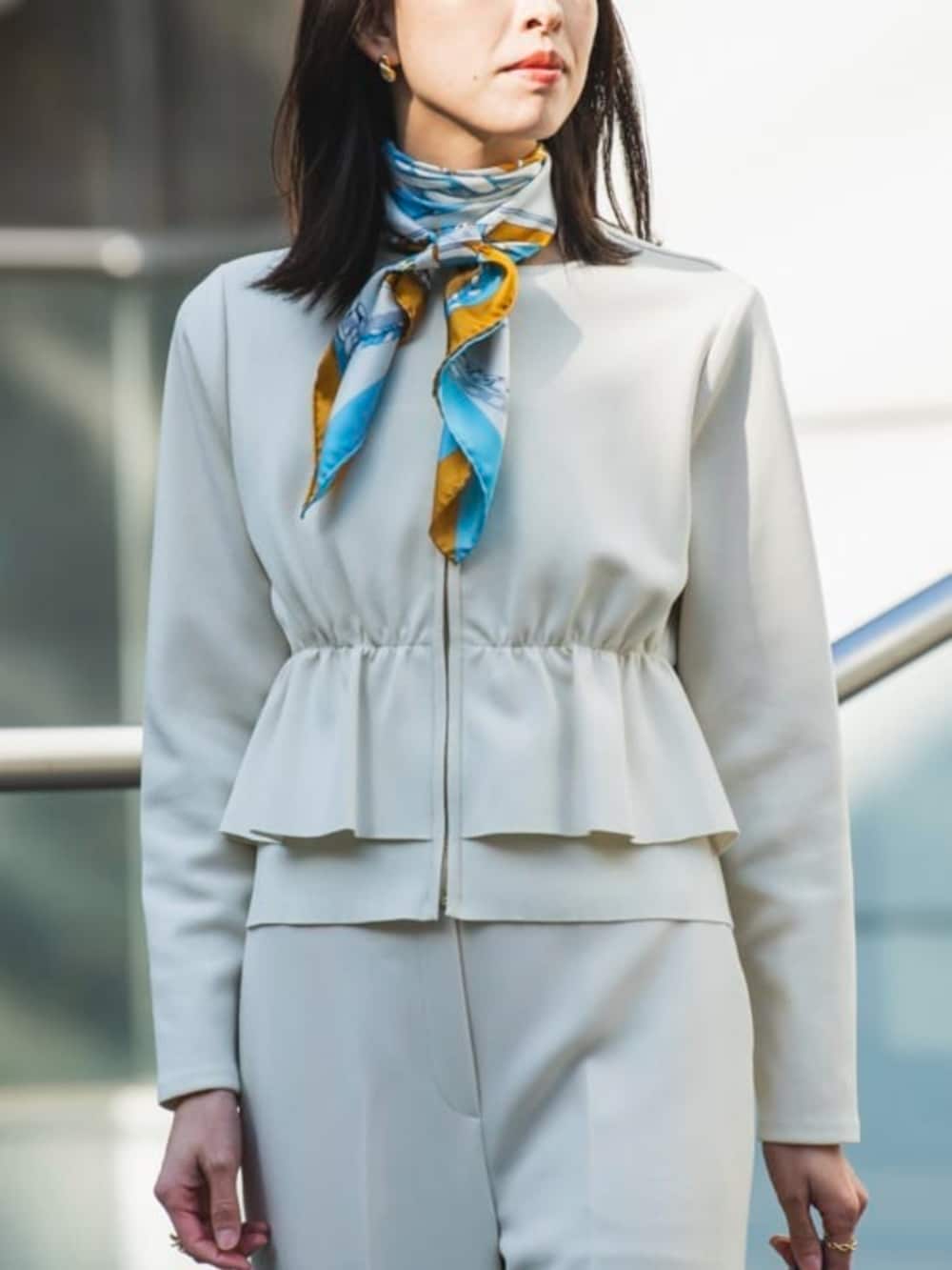 ホワイト系のカーディガン/ボレロ、ベージュ系のスラックス、ブルー系のバンダナ/スカーフを着用したレディースの冬コーディネートの2枚目の写真