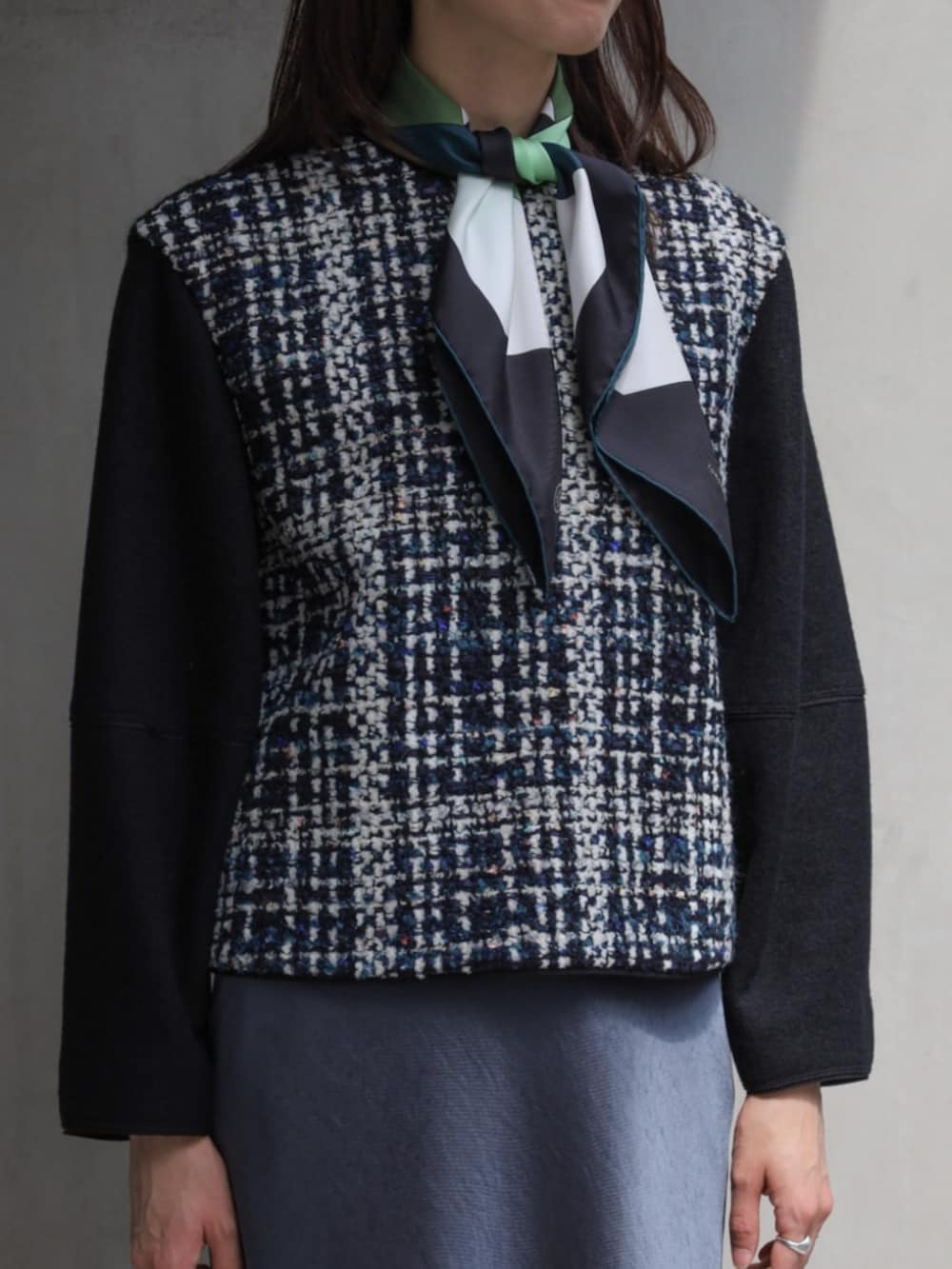 ブラック系のその他トップス、ブラック系のブーツ、ホワイト系のハンドバッグを着用したレディースの秋コーディネートの2枚目の写真