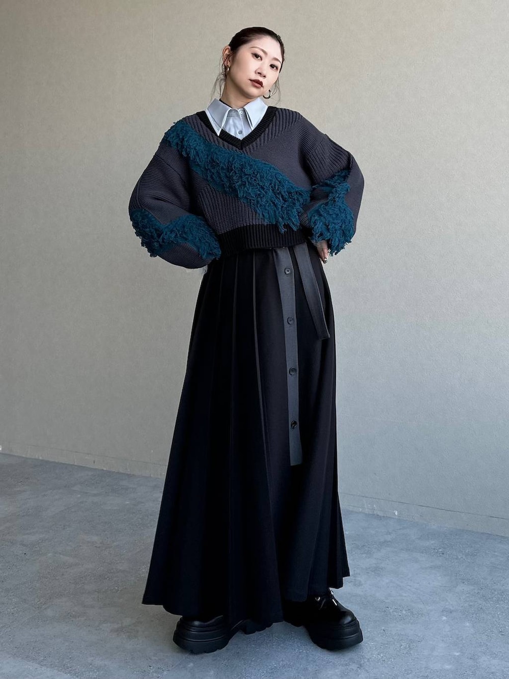 ブラック系のスカート、ブルー系のニット/セーターを着用したレディースの冬コーディネートの6枚目の写真