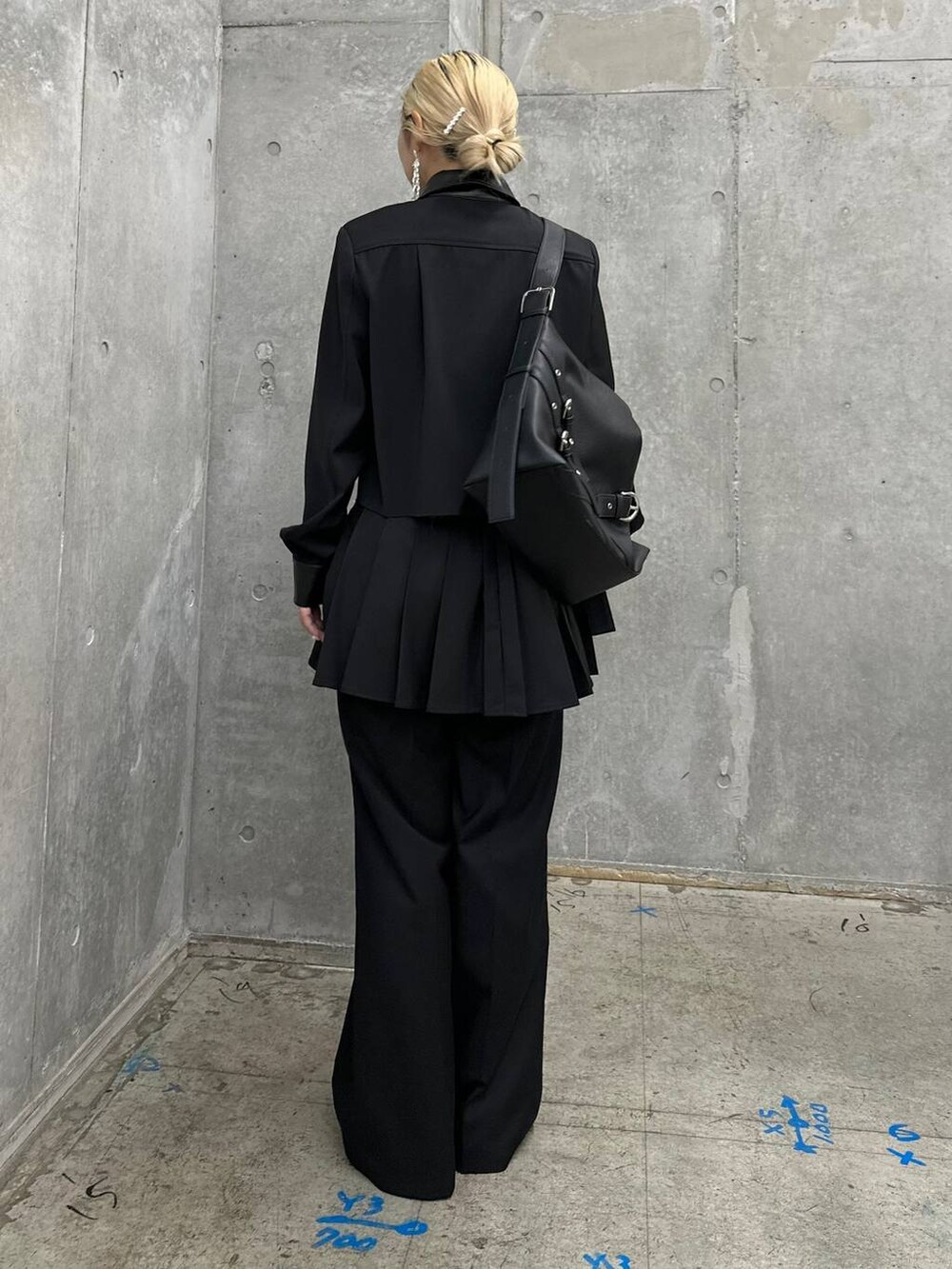 ブラック系のショルダーバッグ、ブラック系のバレエシューズ、シルバー系のピアス（両耳用）を着用したレディースの秋コーディネートの2枚目の写真